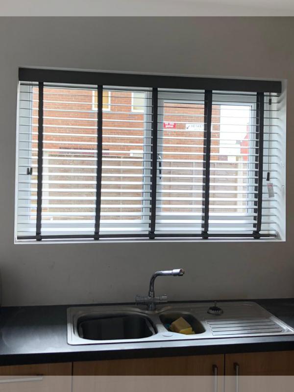 Taped Wooden Venetian Blinds in a Kitchen