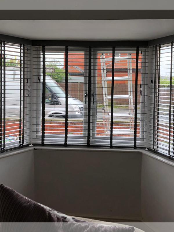 Taped Wooden Venetian Blinds in a Large Bay Window