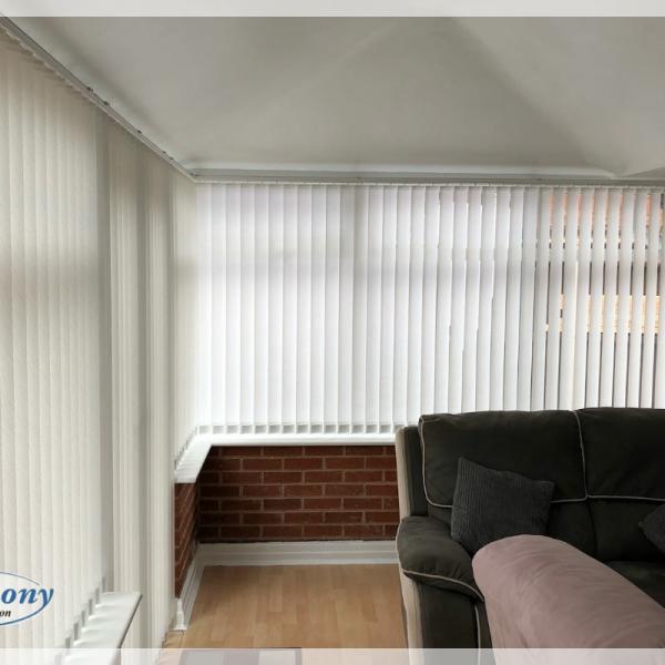 White Textured Vertical Blinds in a Conservatory